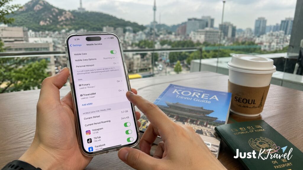 Tourist setting up Korea eSIM on smartphone while planning Seoul trip