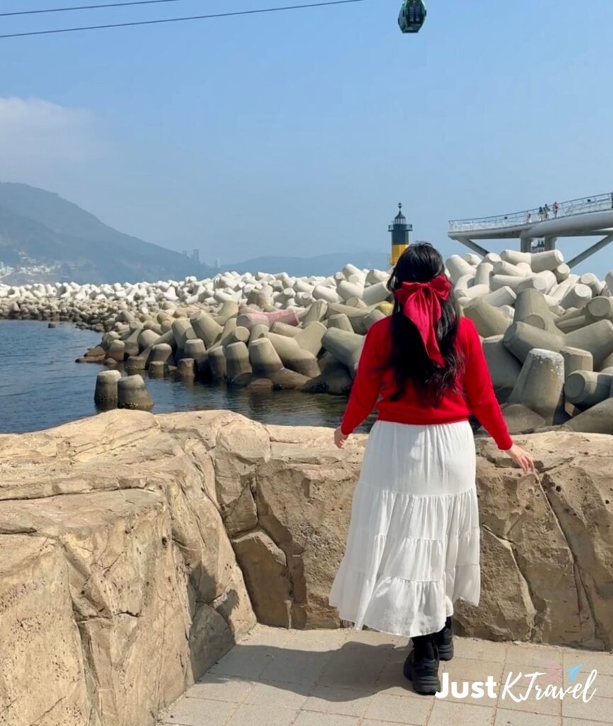 Solo traveler at Songdo Skywalk Busan South Korea ocean walkway