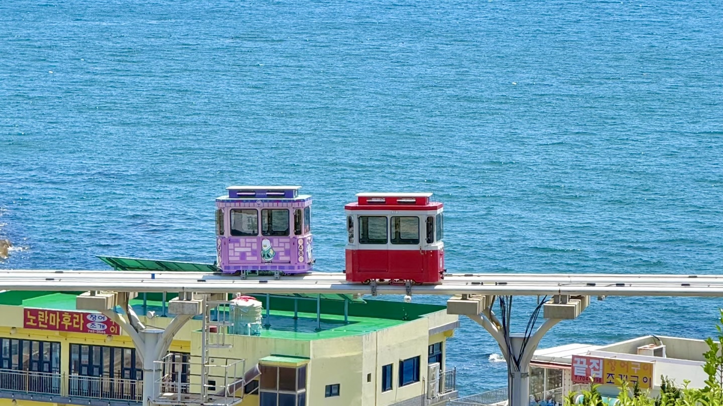Busan Sky Capsule traveling along the coastline with Haeundae Beach and ocean view in South Korea