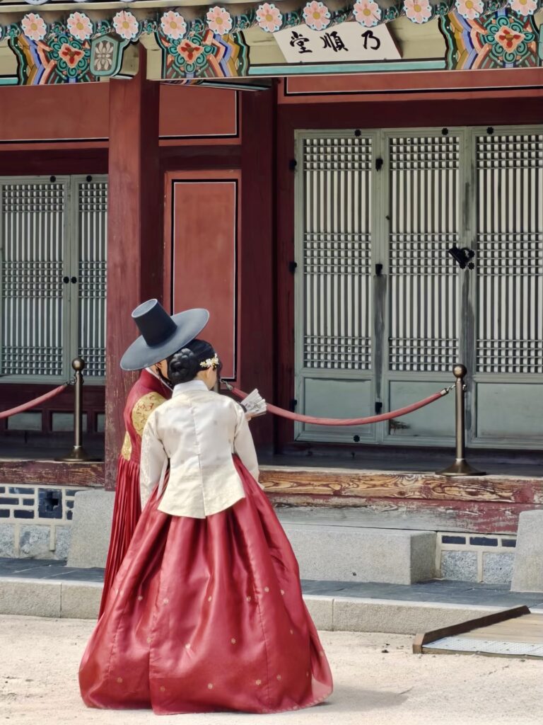 Couple wearing hanbok walking at Gyeongbokgung Palace in Seoul Korea