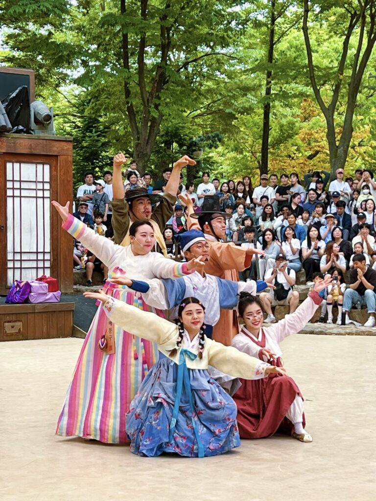 Visitors wearing hanbok at Korean Folk Village experiencing traditional Korean culture