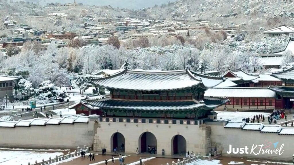 Gwanghwamun Gate and snow-covered mountain in Seoul during winter