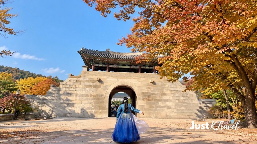 Woman wearing hanbok at Gyeongbokgung Palace during autumn