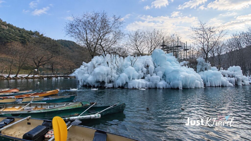 Frozen lake with towering ice walls and a boat at Gyeongju Healing Park in South Korea